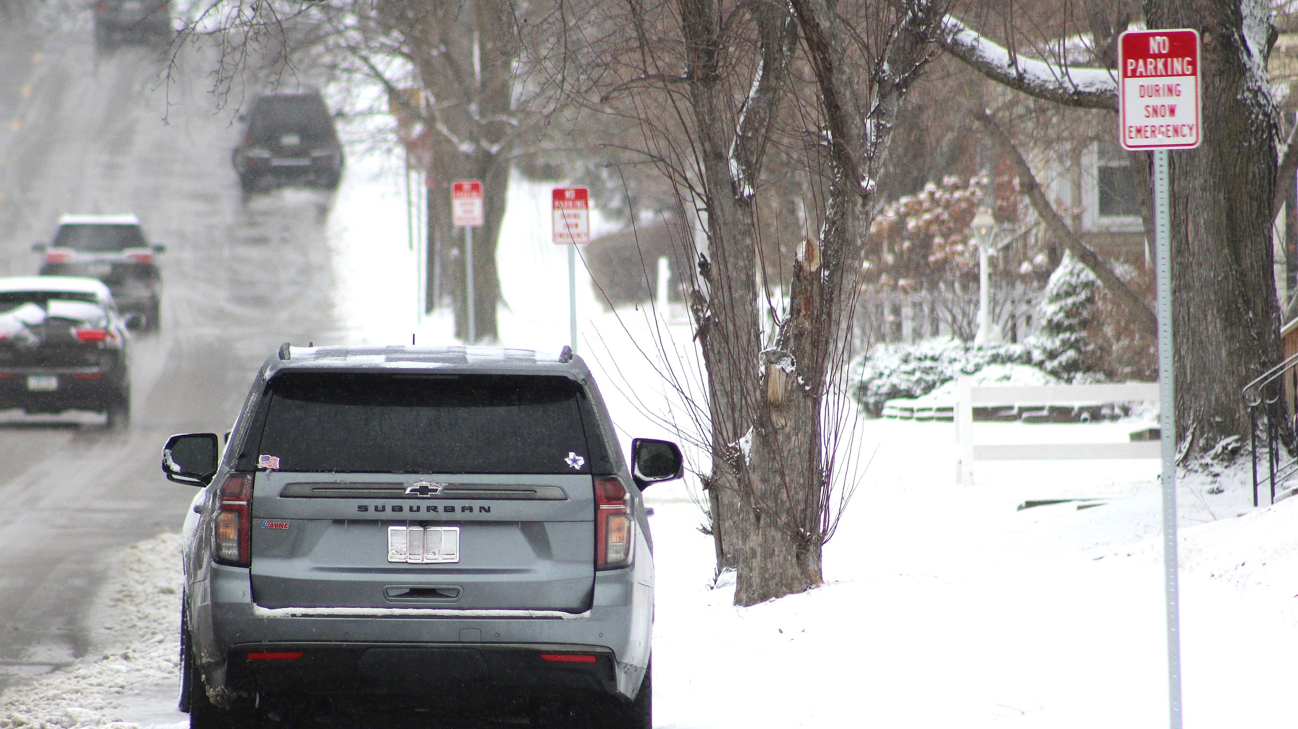 Snow Emergency Parking showing car parked on snowy street with new signs 021623 (JPG)