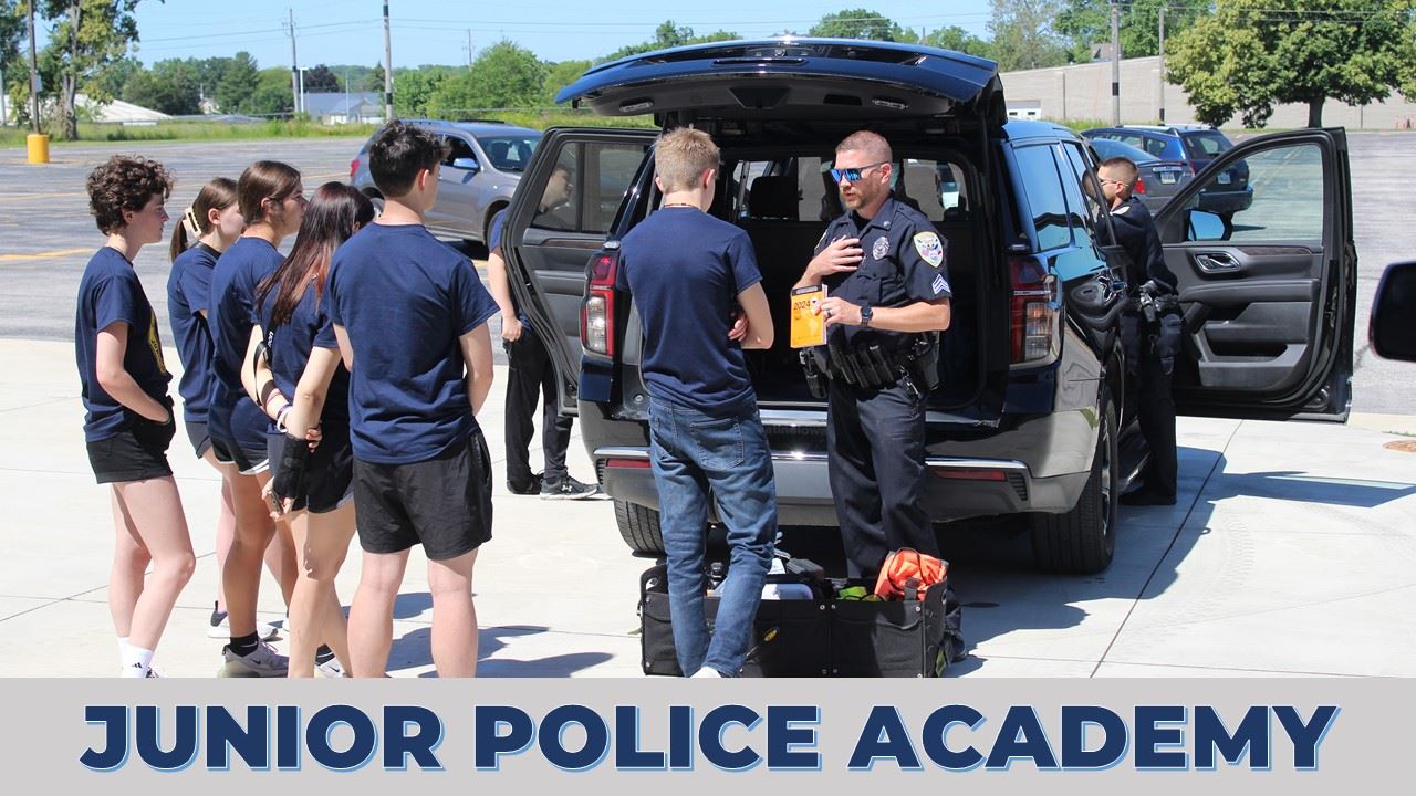Junior Police Academy Promo (JPG) showing students looking at police car (JPG)
