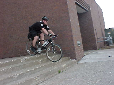 Officer riding bike down stairs
